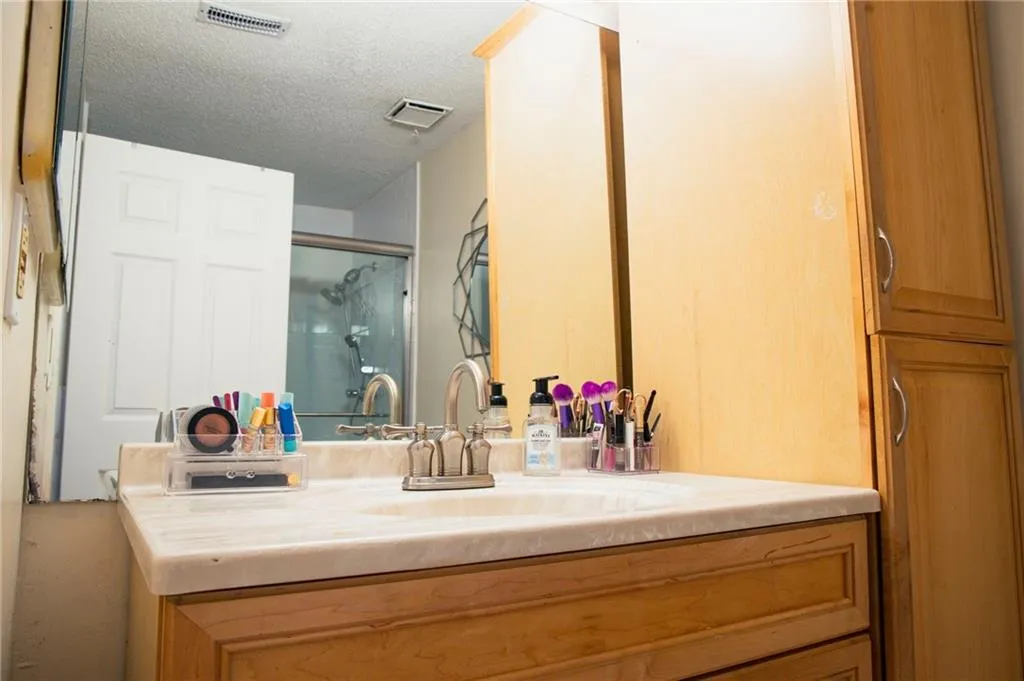 Bathroom featuring vanity and a textured ceiling