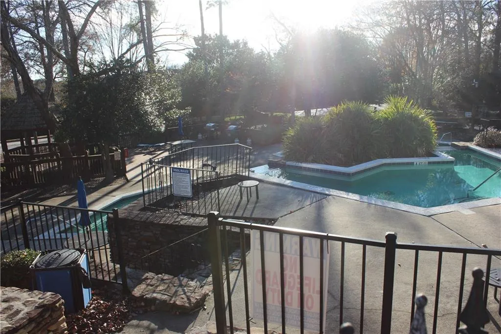Community pool with a patio