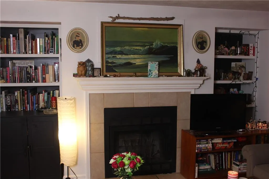 Living area with a tile fireplace