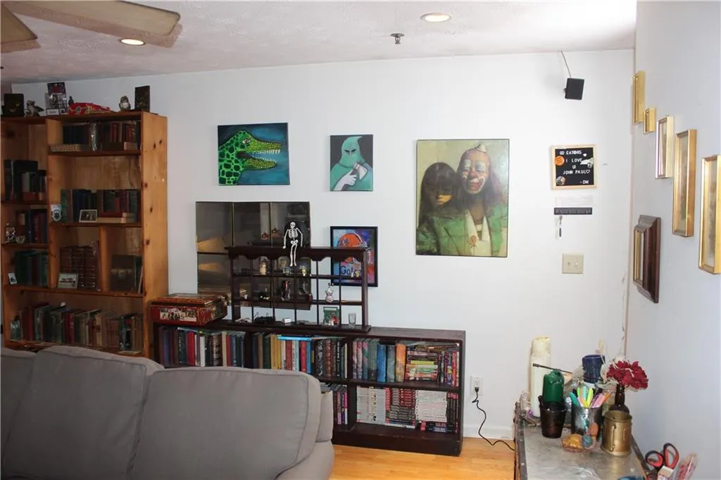 Living area with wood finished floors and recessed lighting