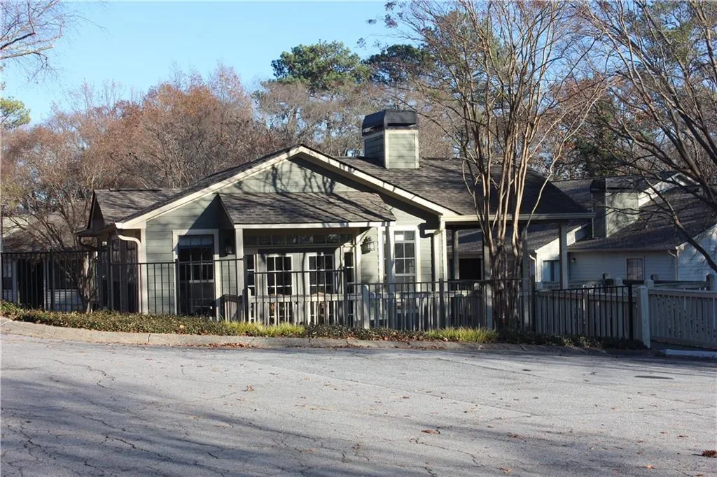 Bungalow-style home featuring a fenced front yard and a chimney