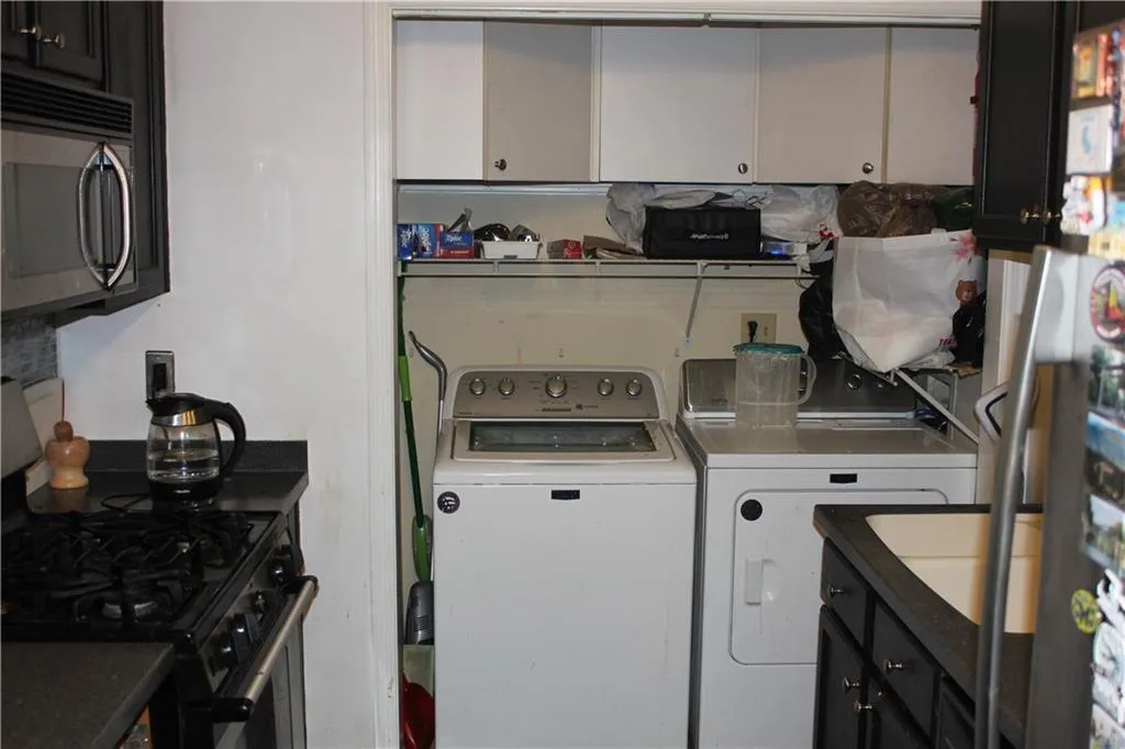 Washroom featuring washing machine and dryer