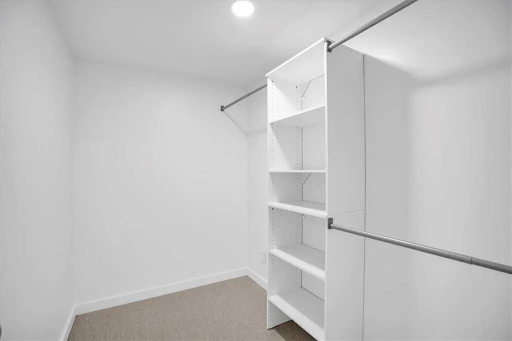 Primary bedroom walk in closet