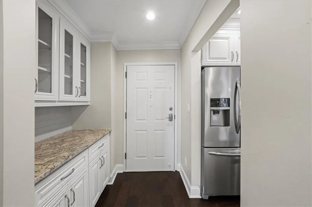 Stepping into this new home, you are greeted with a great space for storage, extra items on the granite countertops and overflow glassware.