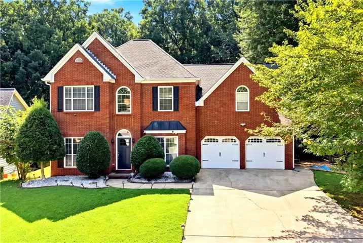 Brick Colonial featuring a two-story design with multiple gabled rooflines and architectural detail