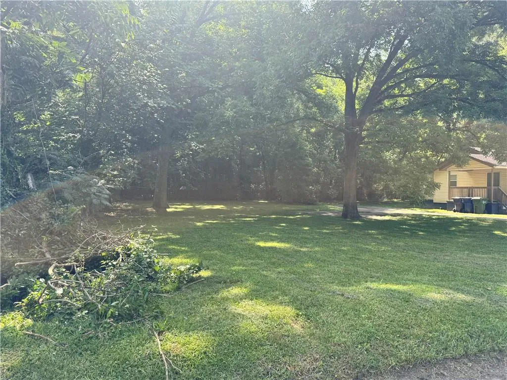 Expansive green space featuring established trees and natural foliage