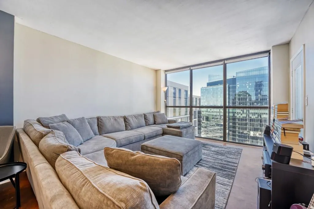 Living area featuring a view of city and expansive windows