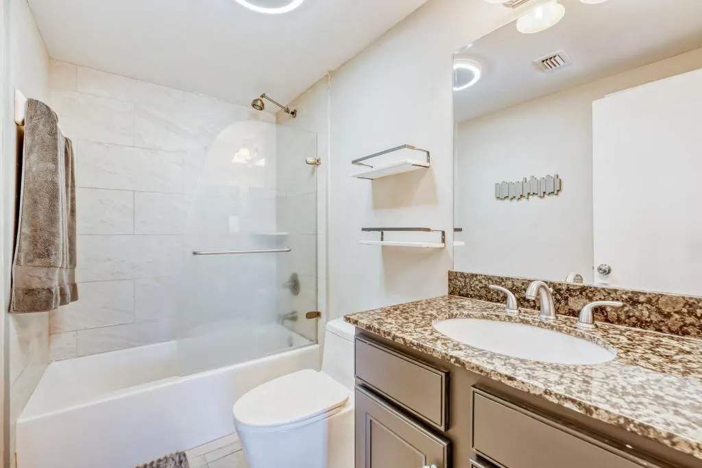 Bathroom featuring vanity and  shower combination