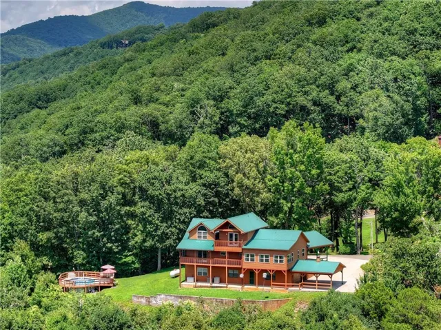 Striking red barn-style residence nestled within mature woodland setting