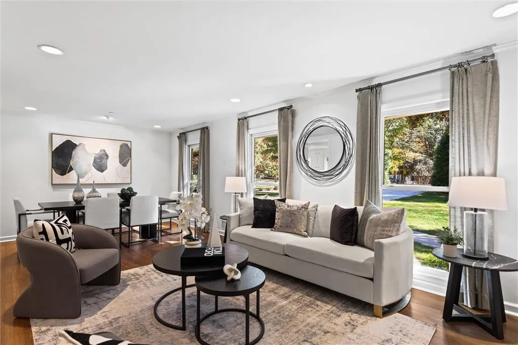 Living area with healthy amount of natural light, dark wood finished floors, and recessed lighting