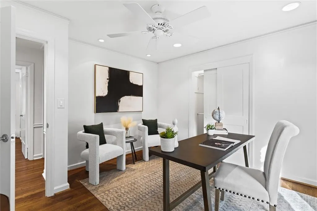Office space with dark wood finished floors, recessed lighting, ornamental molding, and a ceiling fan