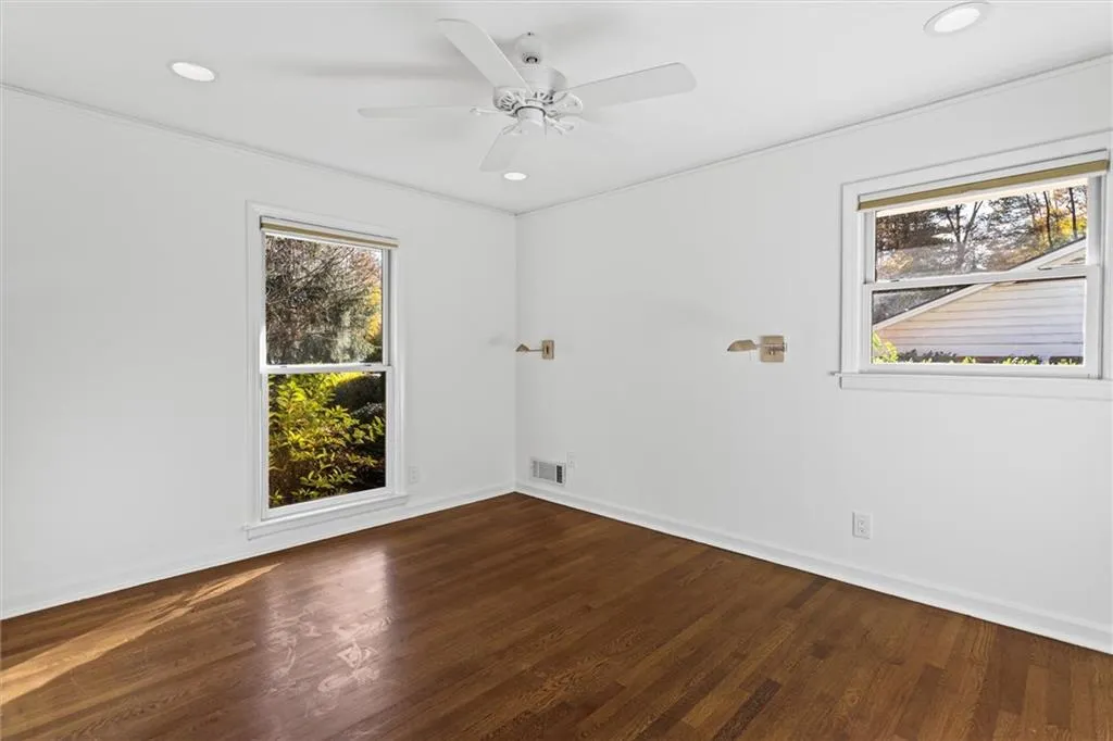 Unfurnished room featuring dark wood-type flooring, recessed lighting, crown molding, and a ceiling fan