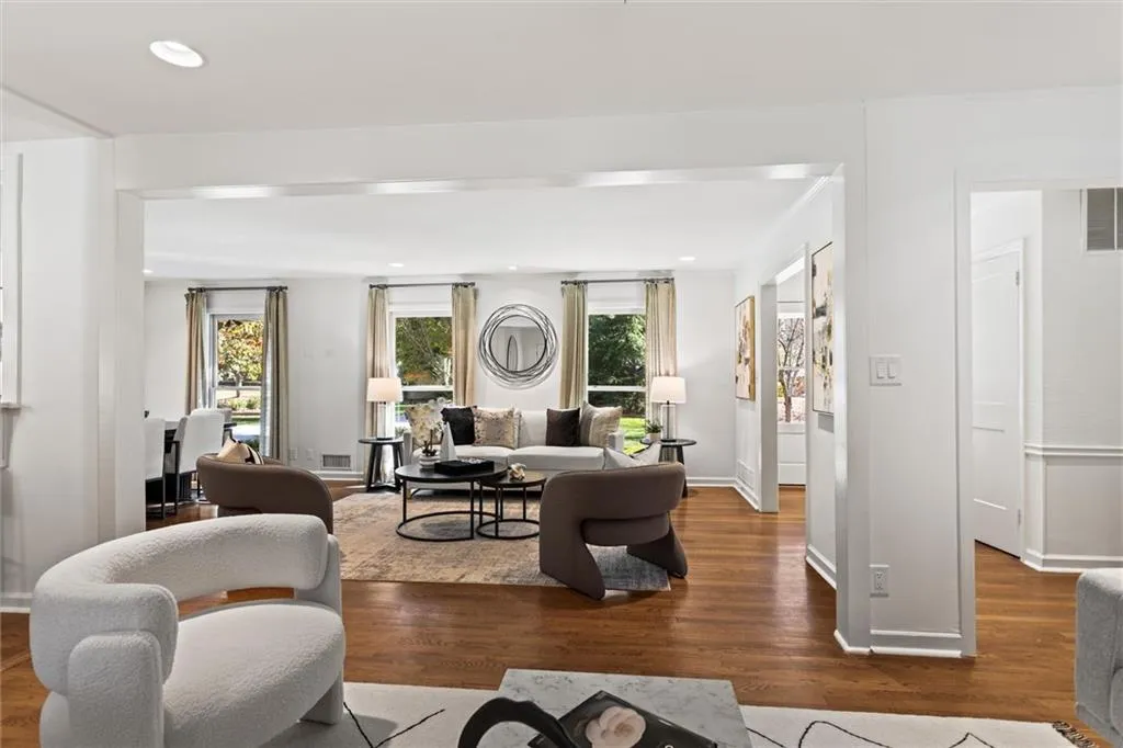 Living area with wood finished floors and recessed lighting