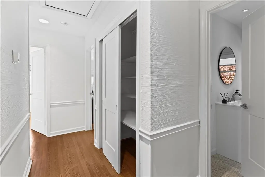Corridor featuring light wood-style floors and recessed lighting