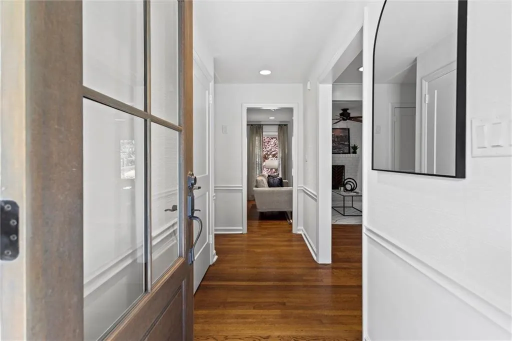 Corridor featuring dark wood-type flooring and recessed lighting