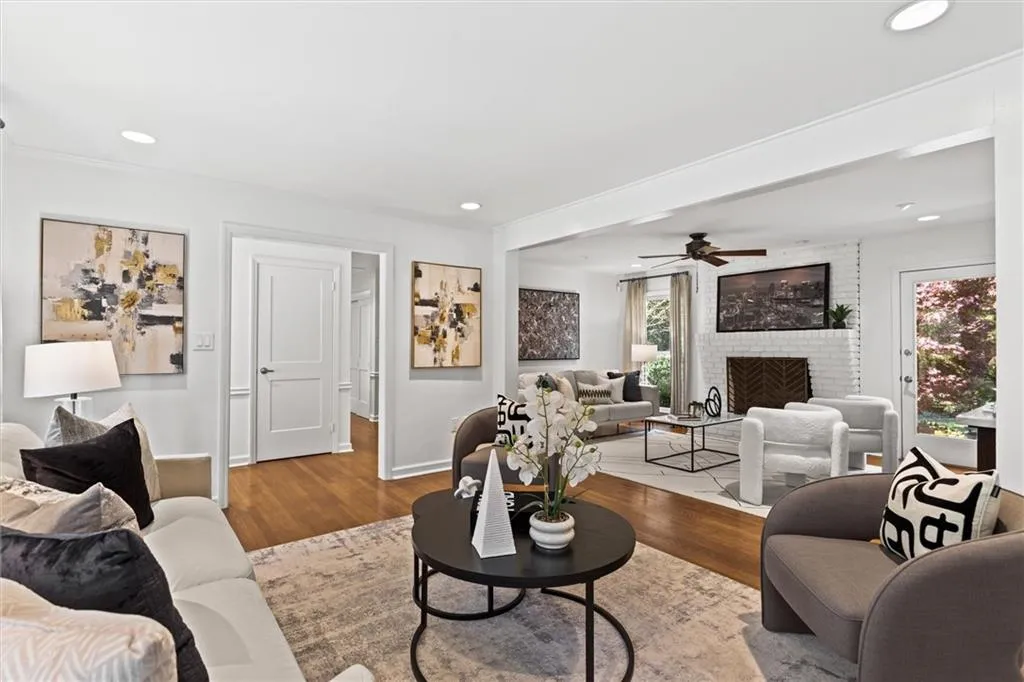 Living room featuring a fireplace, wood finished floors, recessed lighting, and ceiling fan