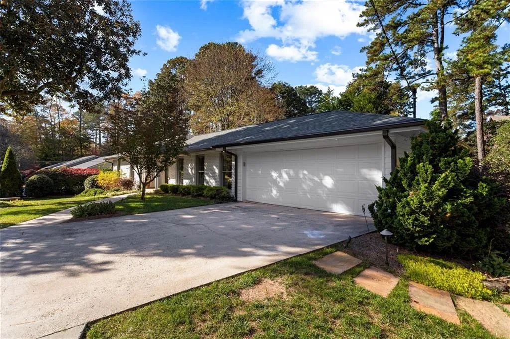 View of front of house featuring concrete driveway, a garage, and a front yard