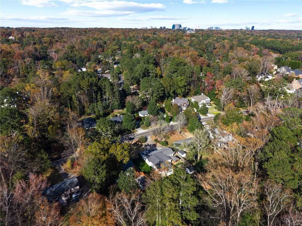 View of property location featuring a forest