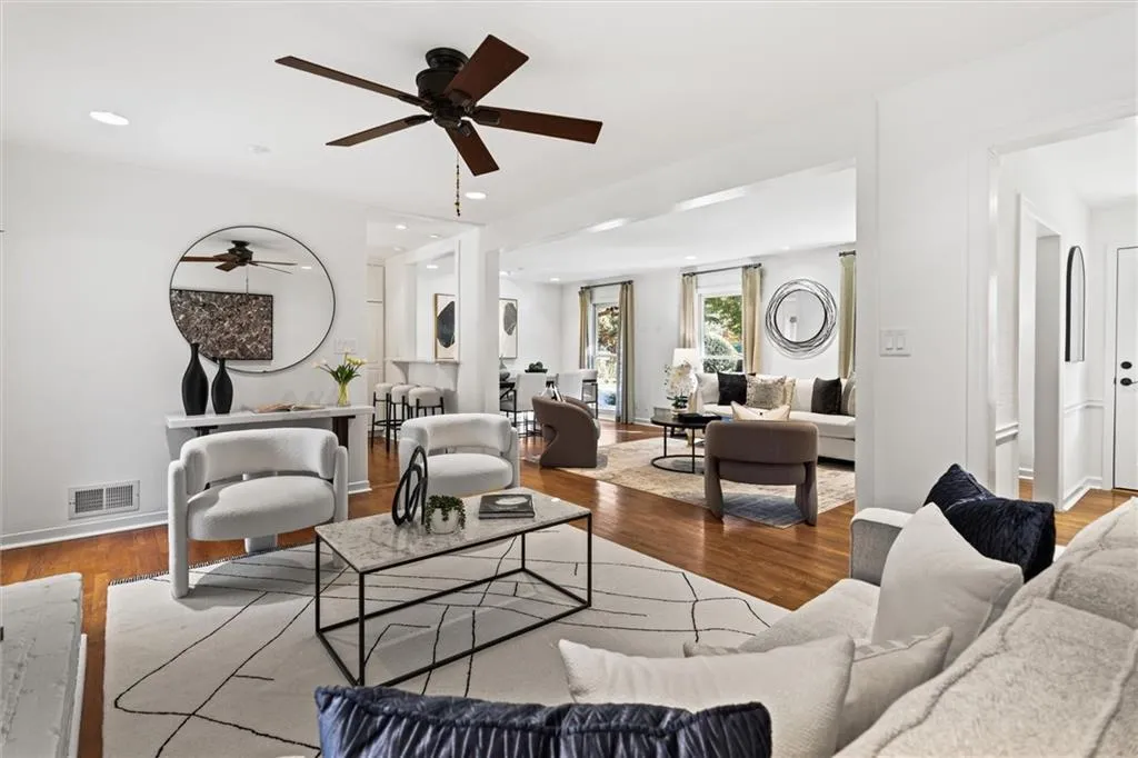 Living area featuring wood finished floors, ceiling fan, and recessed lighting