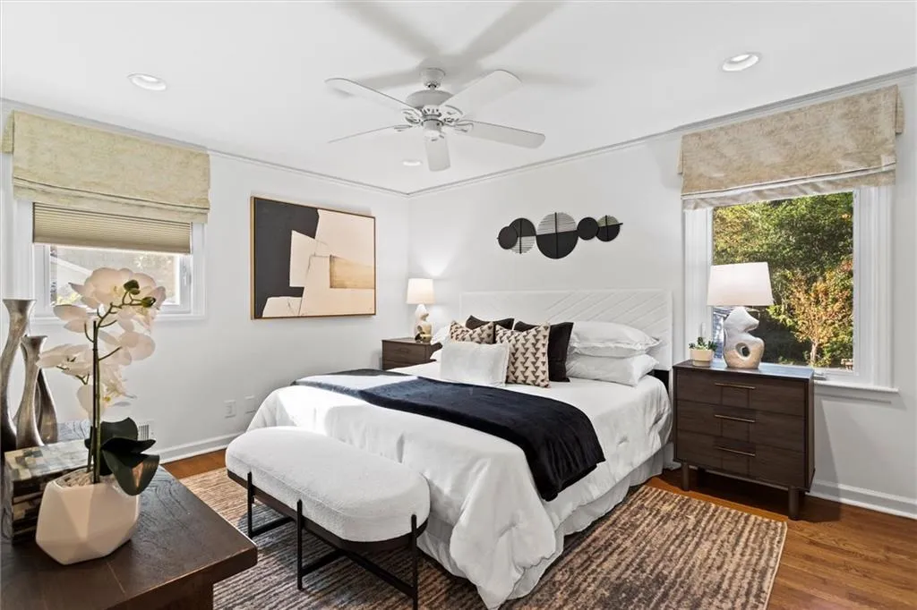 Bedroom featuring multiple windows, dark wood-type flooring, recessed lighting, a ceiling fan, and crown molding