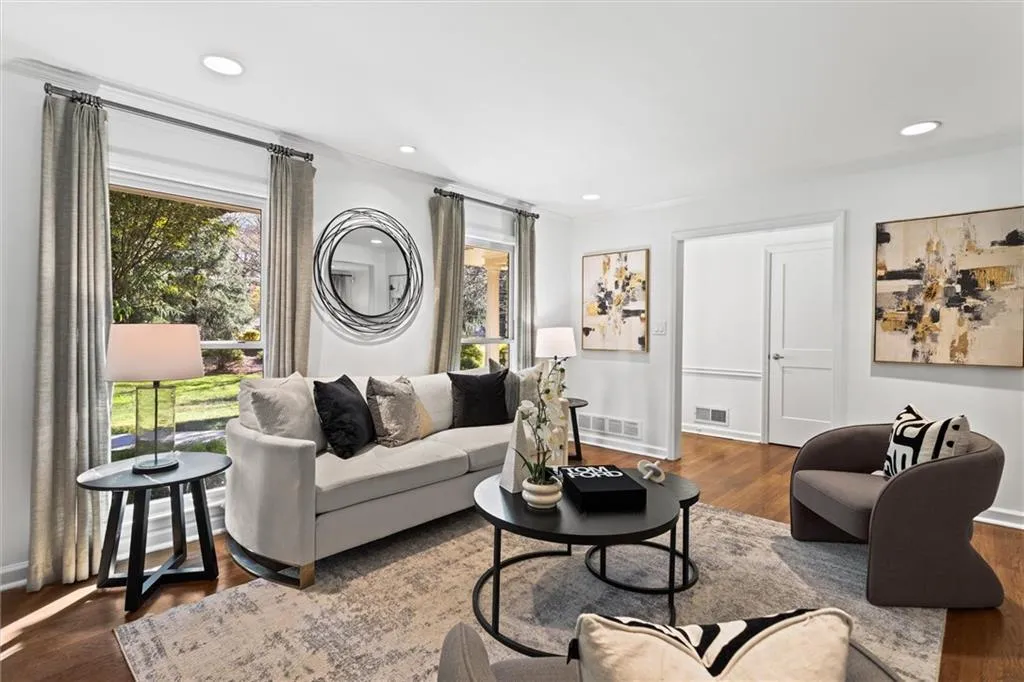 Living area with wood finished floors and recessed lighting