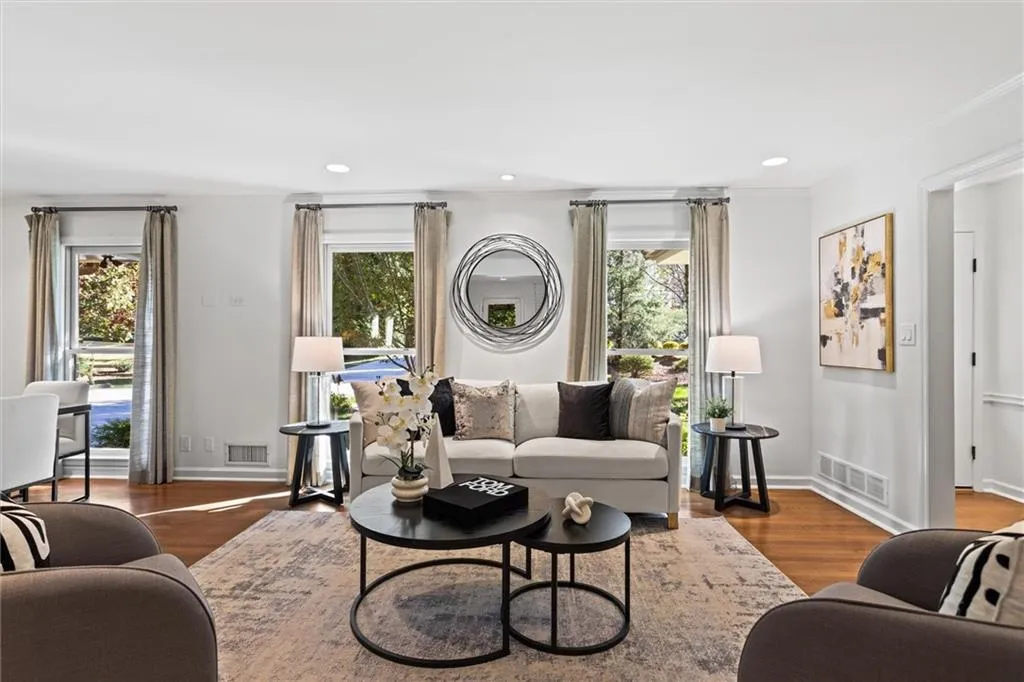 Living area featuring wood finished floors, recessed lighting, and crown molding