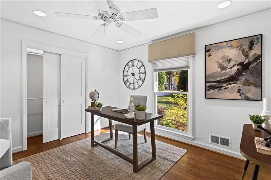 Office space featuring dark wood-style floors, recessed lighting, ceiling fan, and crown molding