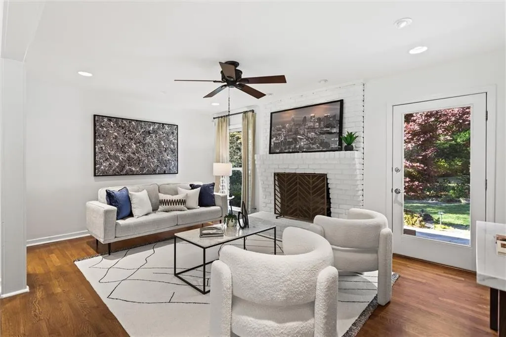 Living area featuring a brick fireplace, dark wood finished floors, ceiling fan, and recessed lighting