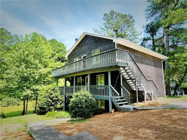 Two-story exterior with horizontal siding and a multi-level deck featuring a staircase