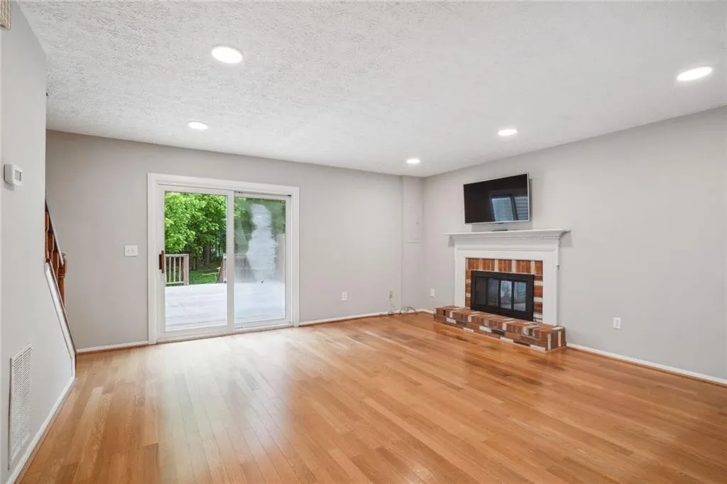 featuring light hardwood floors and gas fireplace