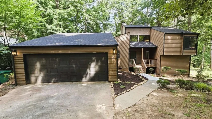 Multi-level facade with wood siding and contrasting trim