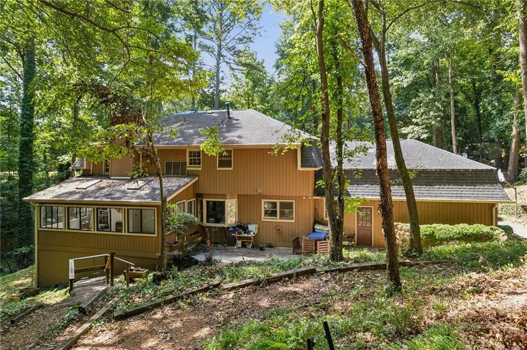 Rear view of house featuring a wooden deck