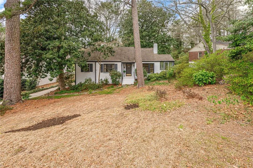 Ranch-style house with a chimney and a shingled roof