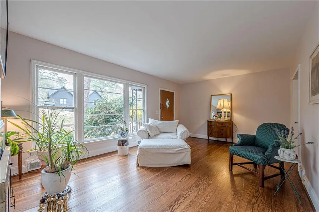 Lot of Natural light in the Living area with hardwood floors and fireplace