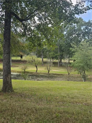 View of property's community with a lawn