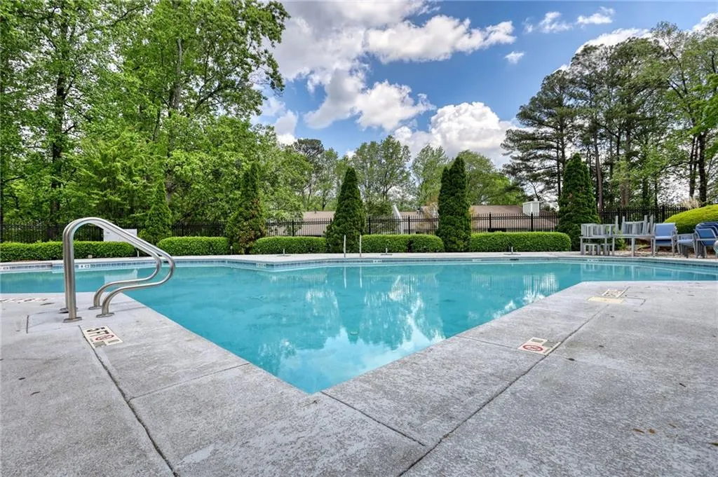 Community pool with a patio