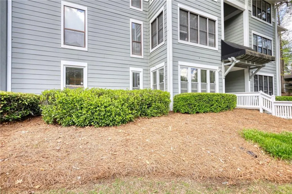 View of side of home featuring a balcony