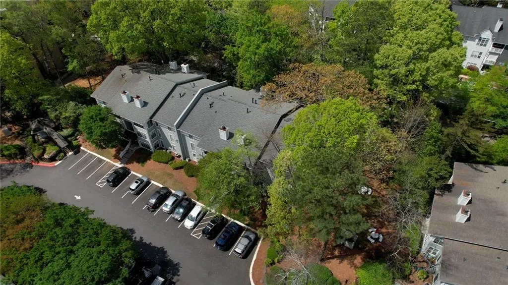 View of property location featuring a tree filled landscape
