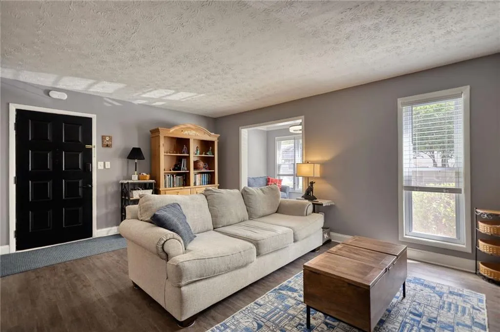 Living room featuring wood finished floors and a textured ceiling