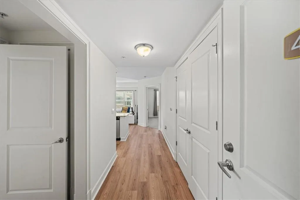Hall with light hardwood / wood-style flooring