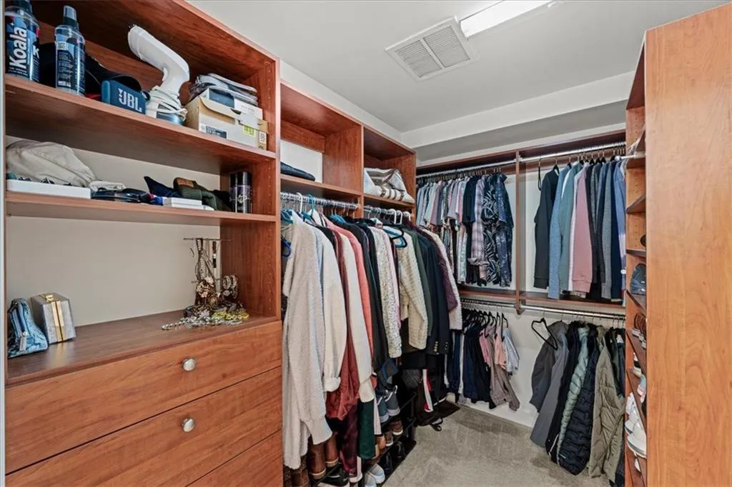 Spacious closet with light carpet