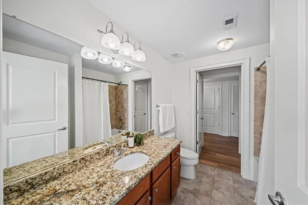 Full bathroom with vanity, toilet, and shower / tub combo