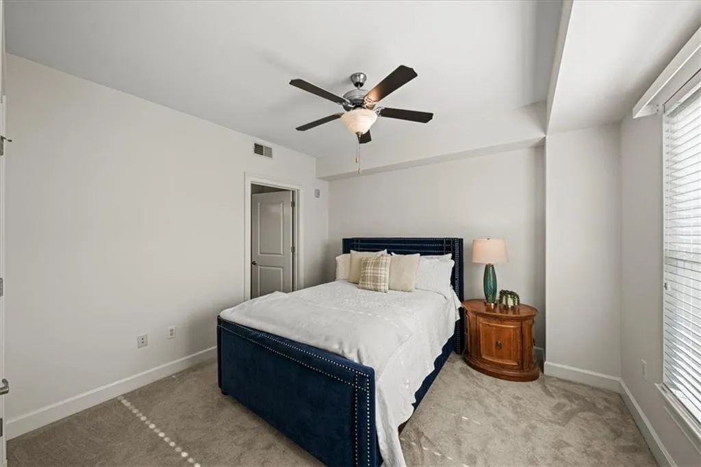 Bedroom featuring ceiling fan and light carpet