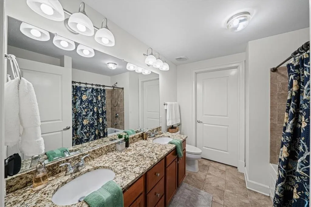 Full bathroom with vanity, toilet, and shower / tub combo