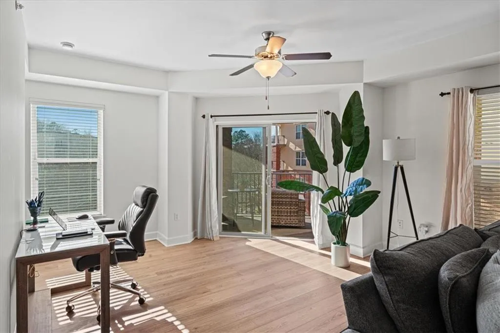 Home office with ceiling fan and light hardwood / wood-style floors