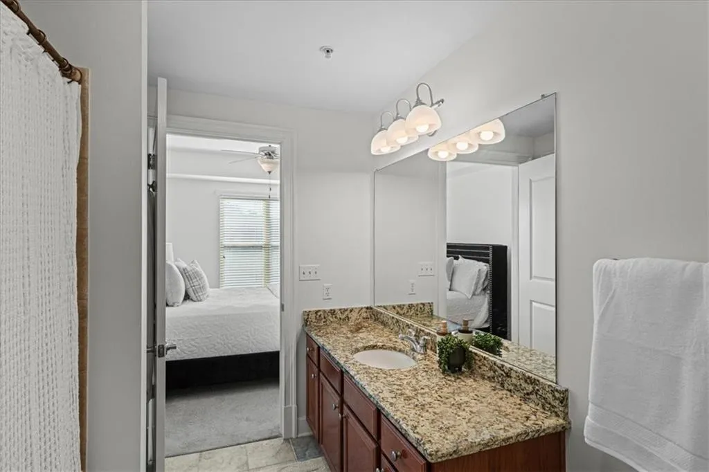 Bathroom with vanity and ceiling fan