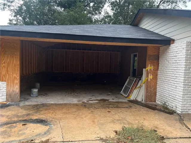 View of parking featuring an attached carport