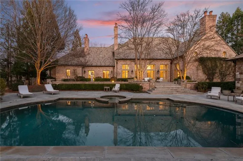 Heated salt water pool with view of the back of the house