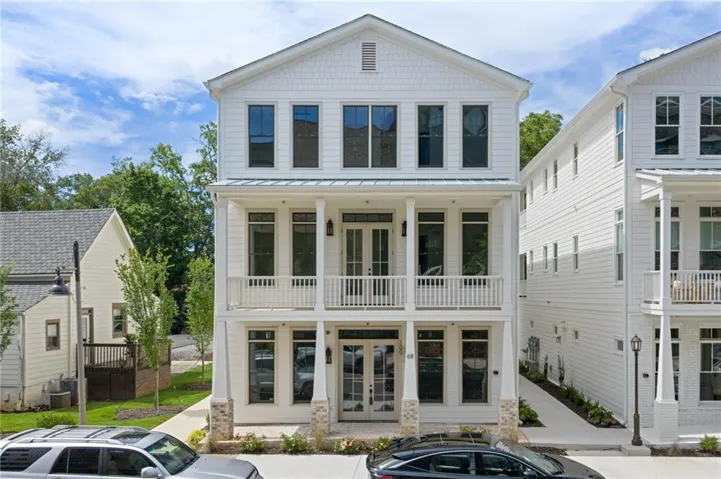 Contemporary architecture with white siding and multiple balconies