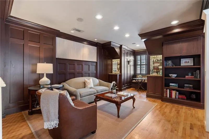 Living area featuring recessed lighting, light wood-type flooring, visible vents, a decorative wall, and ornamental molding